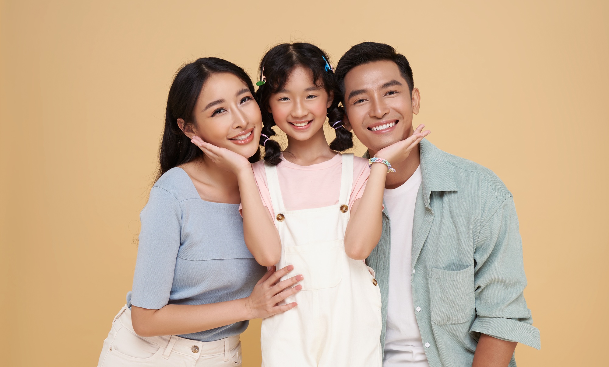Portrait family of three happy smiling Asian family hugging and love together